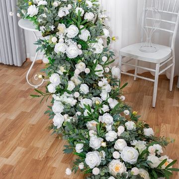 Elegant white floral arrangement cascading indoors.