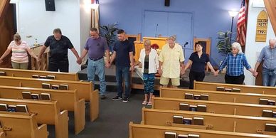 Group holding hands in a church.