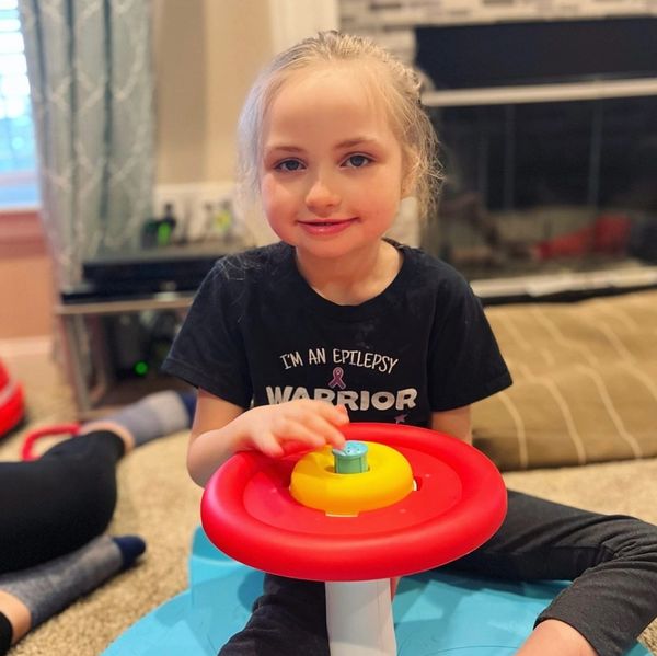 Young girl playing with toy.