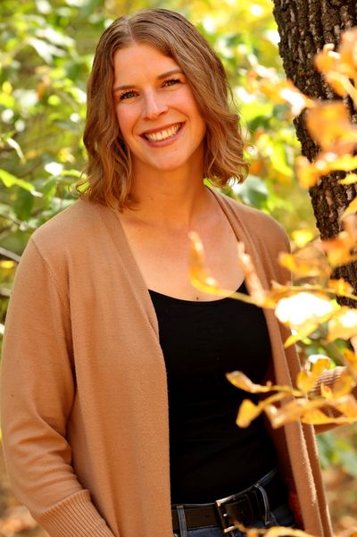 Mary Jane Walker registered dietitian smiling near some green trees