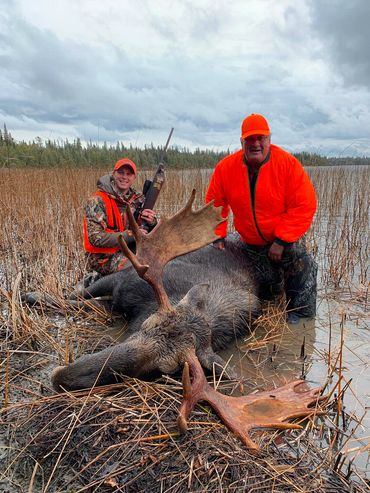 Kevin Beasley with his moose down and his guide David