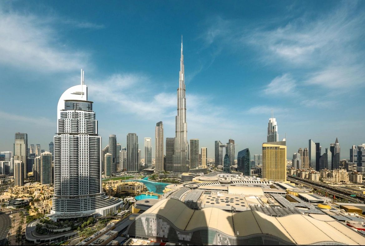 Skyline view of Dubai with Burj Khalifa towering over modern skyscrapers.