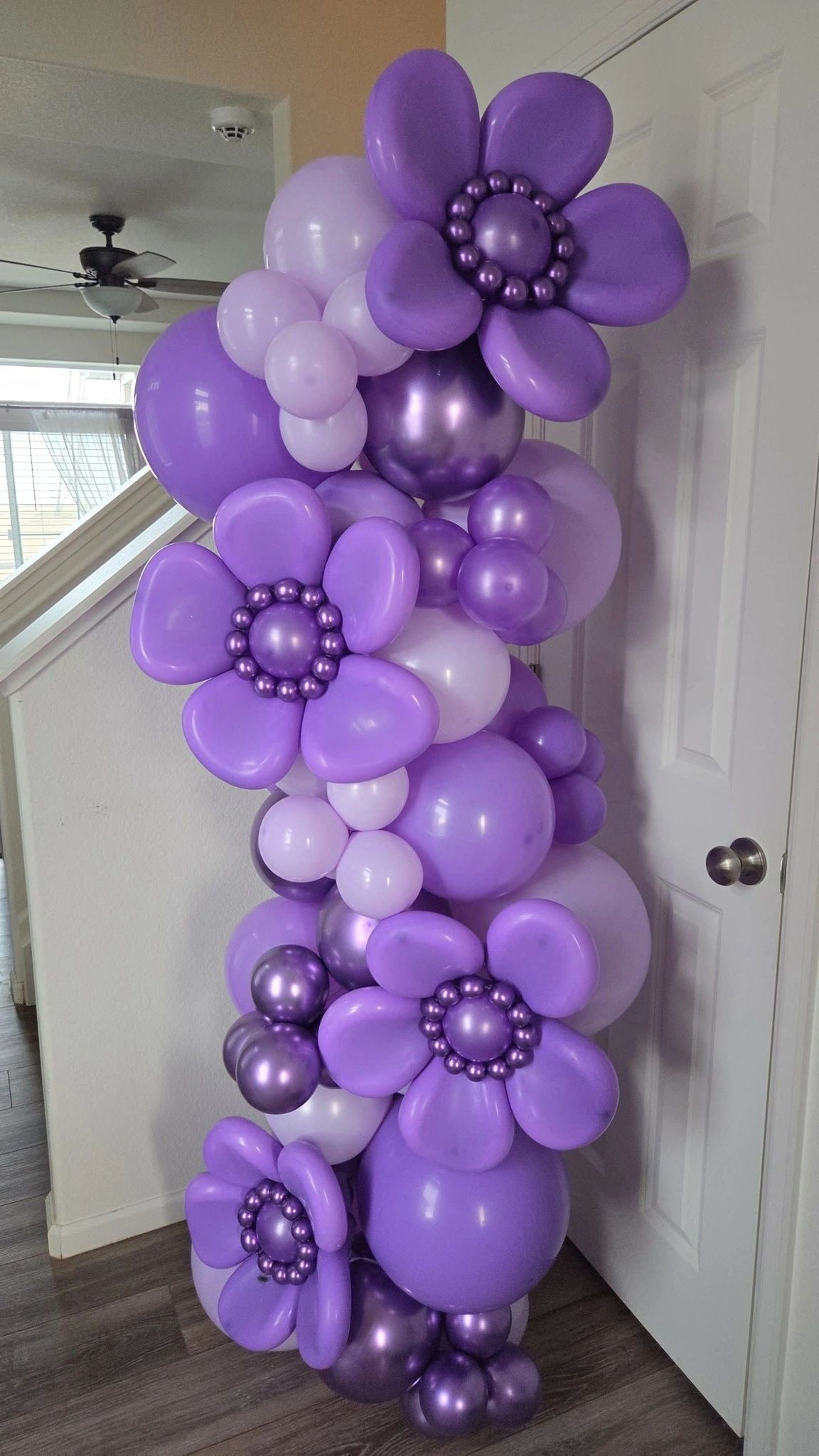 Purple custom balloon garland with floral details for balloon decor in Aurora and Denver.