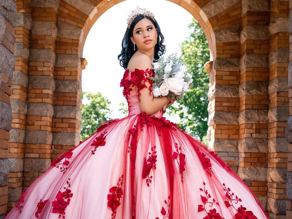 A woman wearing a red and white gown