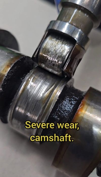 Close-up of a severely worn camshaft.