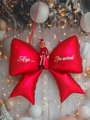 Red bow balloon with elf and lights.