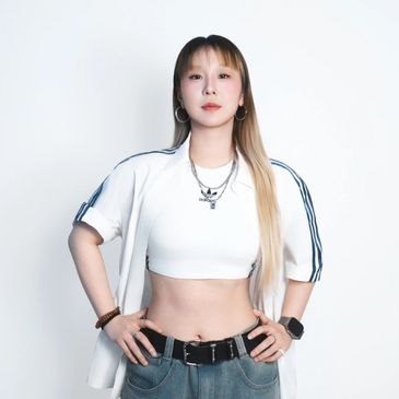 K-pop, Hip Hop, and Locking instructor posing confidently in dance studio