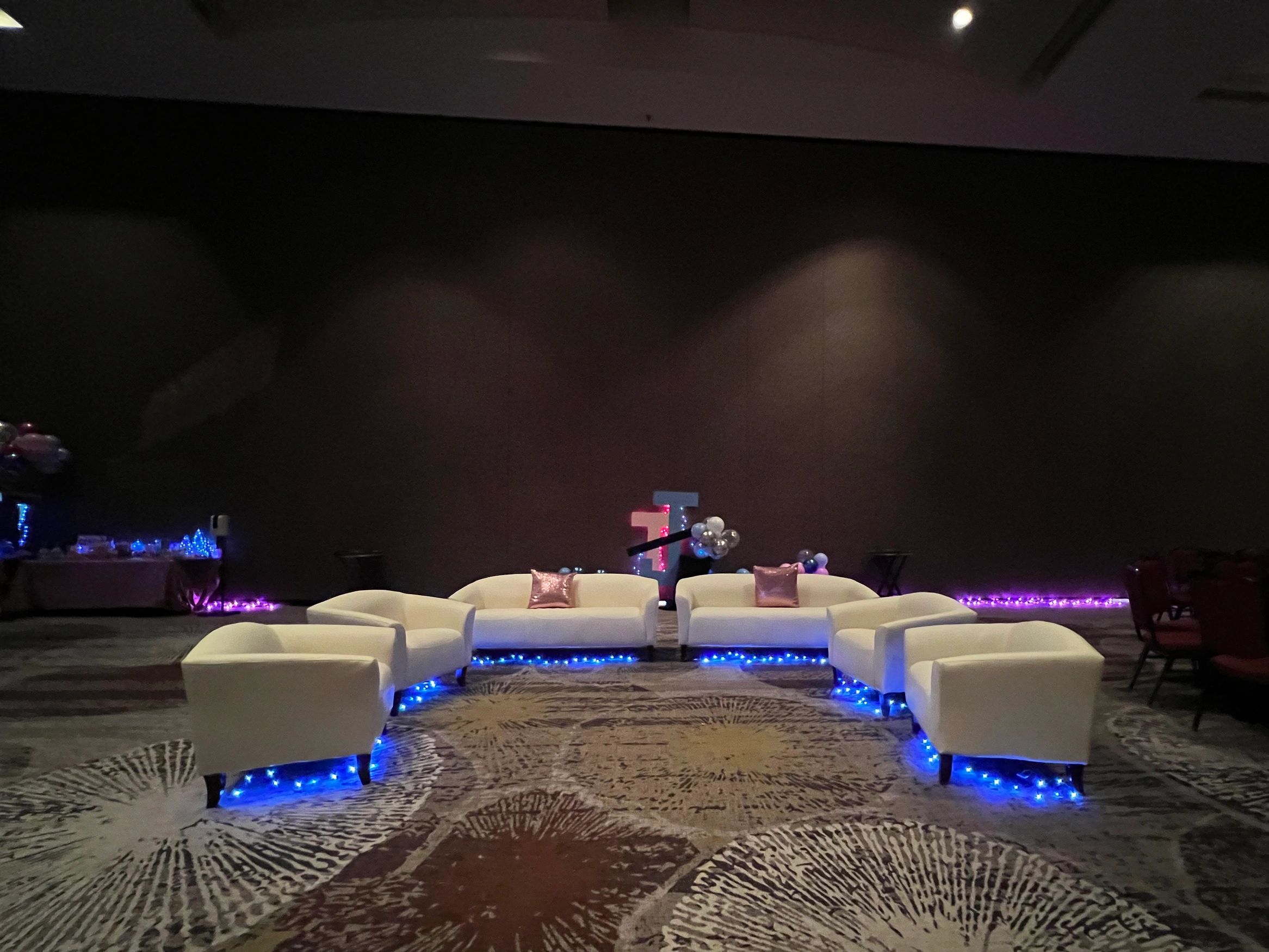 Lounge Area in a Night Club party atmosphere  with white leather sofas & chairs with lights