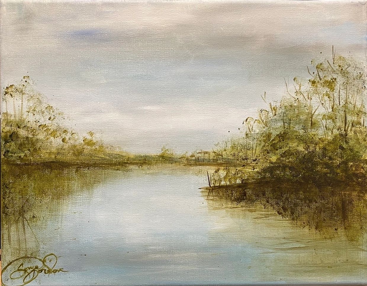 Serene river landscape with soft reflections and muted foliage.