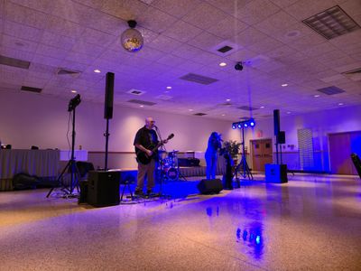 Band performing in a dimly lit indoor venue.