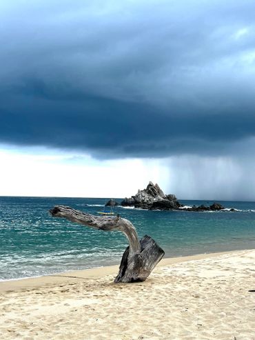Rain over the ocean, taken from a pearly soft sand beach. 