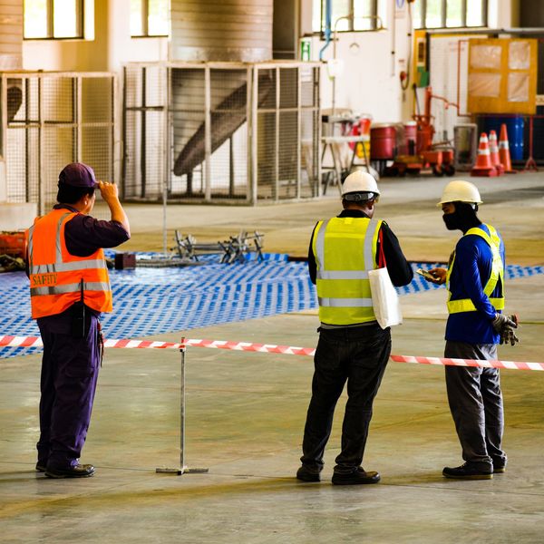 Three engineers standing near a hazardous area