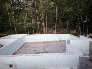 Foundation of a house in a forested area.