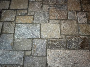 Close-up of a stone brick wall with varied rectangular shapes.
