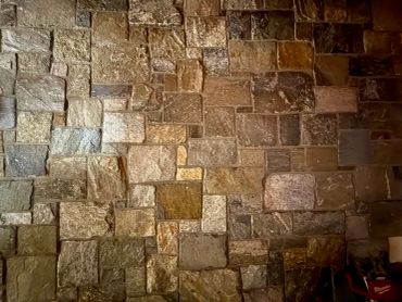 Stone brick wall with varied colors and textures.