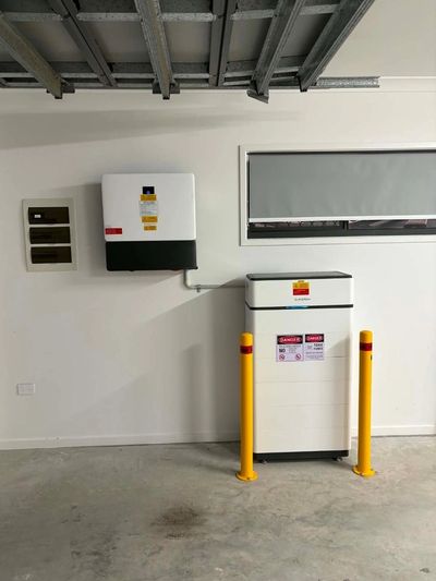 Electric vehicle charging station with safety barriers in a garage.