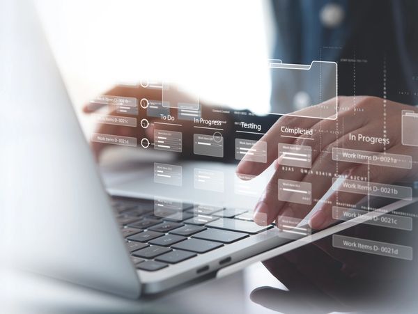 Business developer using Kanban board framework on laptop computer