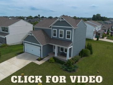 Modern two-story house with attached garage.