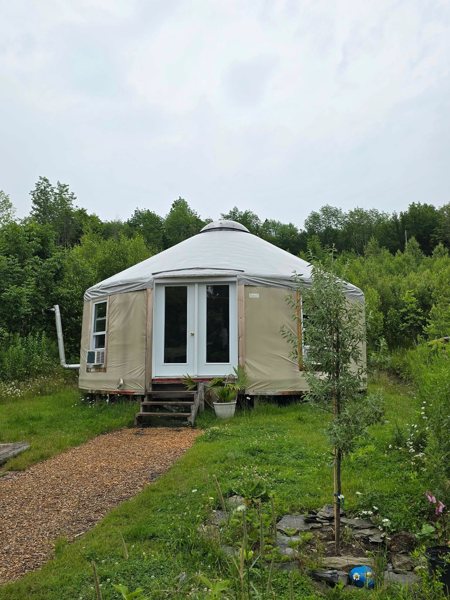 A cozy yurt in a green garden.