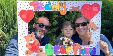Family enjoying a teddy bear picnic.