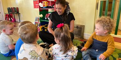 Teacher with young children in a classroom.