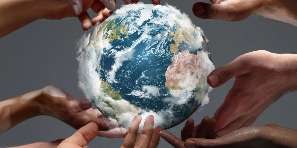 Hand touching and covering the Earth 
