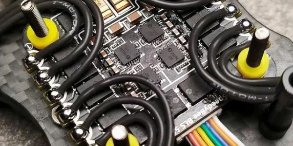 Close-up of electronic circuit board with yellow components and black wiring.