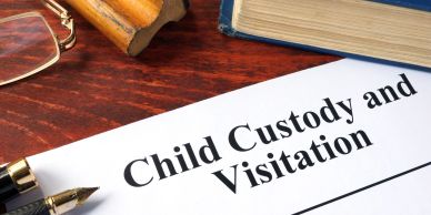 Document titled 'Child Custody and Visitation' on a wooden desk with legal items.