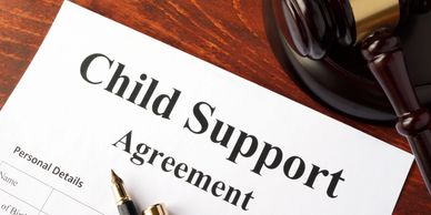 A child support agreement document with a judge's gavel and pen.