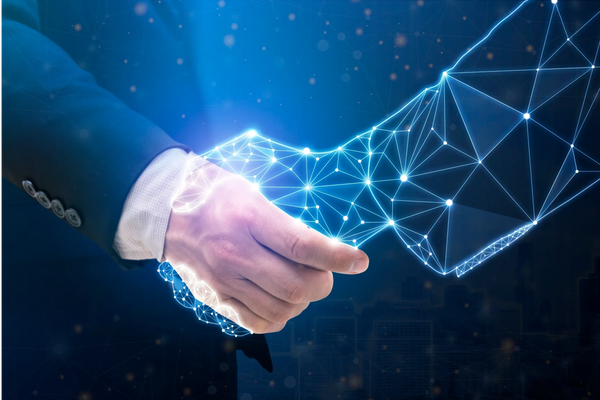 A human hand shaking a digital, networked hand made of glowing lines.