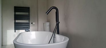 Free standing bath with floor fixed tap.