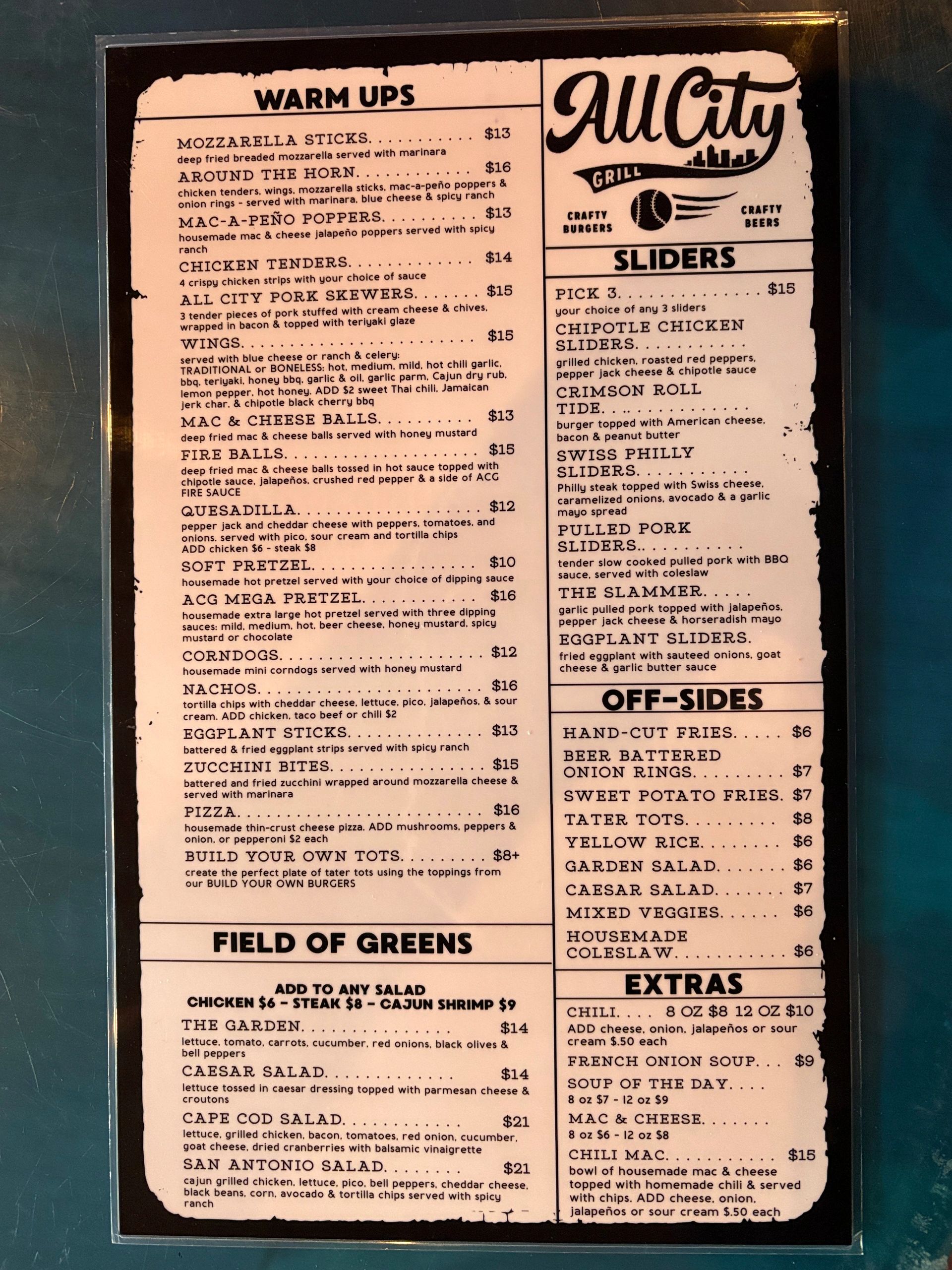 Menu from All City Grill featuring warm ups, sliders, sides, and salads.