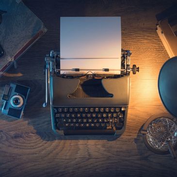 An old fashioned typewriter on a desk.