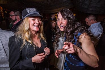 Two woman at a cocktail party.