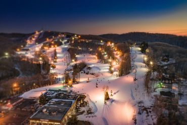 Winterplace Ski Resort lit up after sunset.