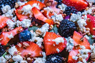 Fruit salad over greens.