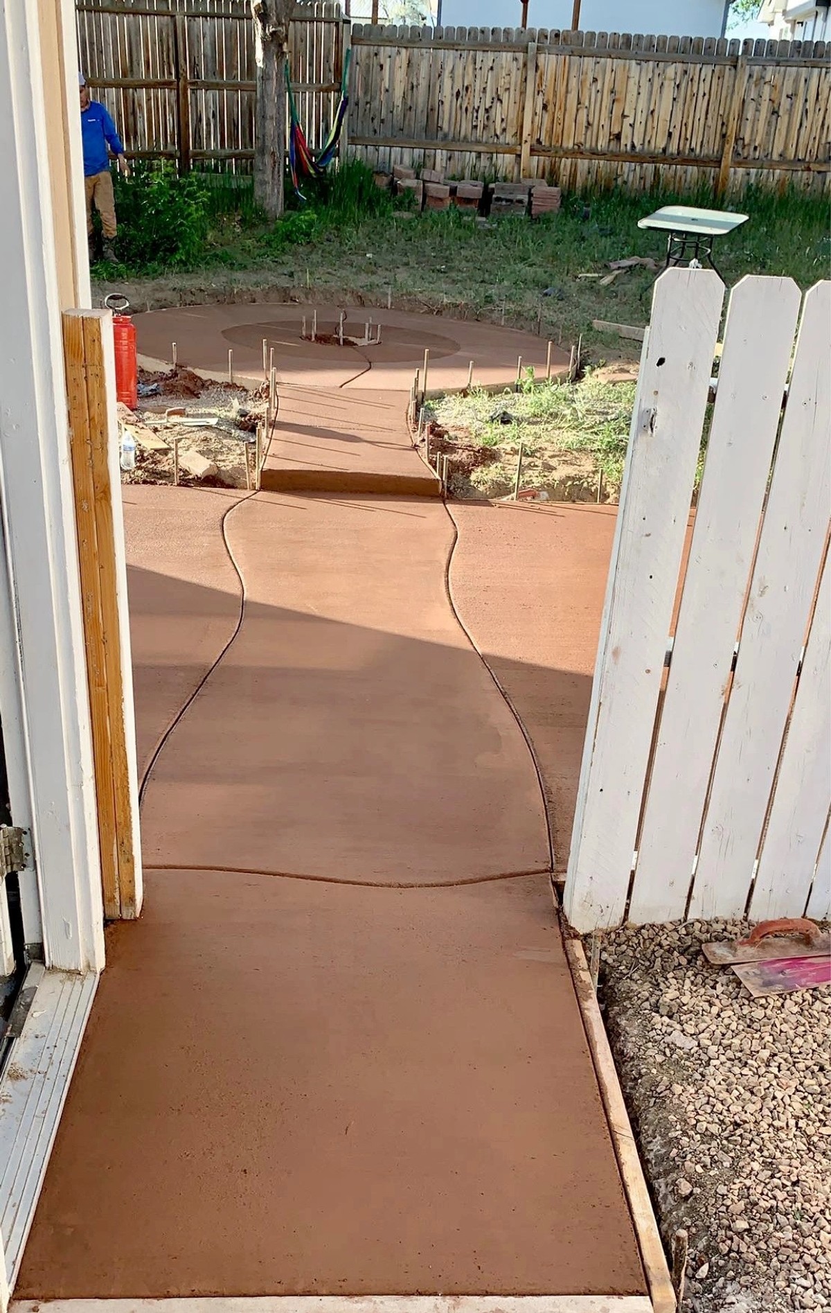 Freshly poured concrete pathway in a backyard