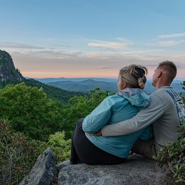 A couple from a marriage retreat enjoying the sunset at Table Rock NC