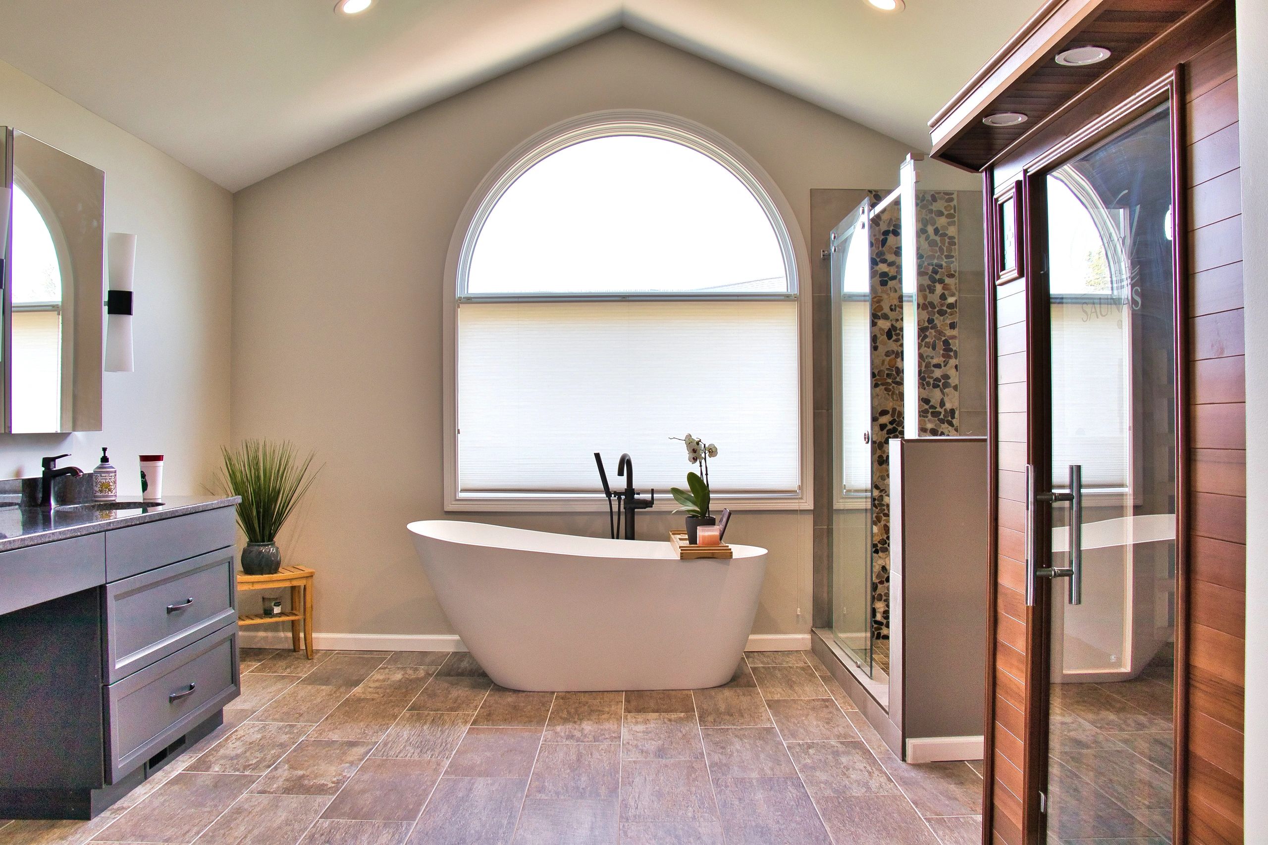 Modern bathroom with a freestanding bathtub and shower.