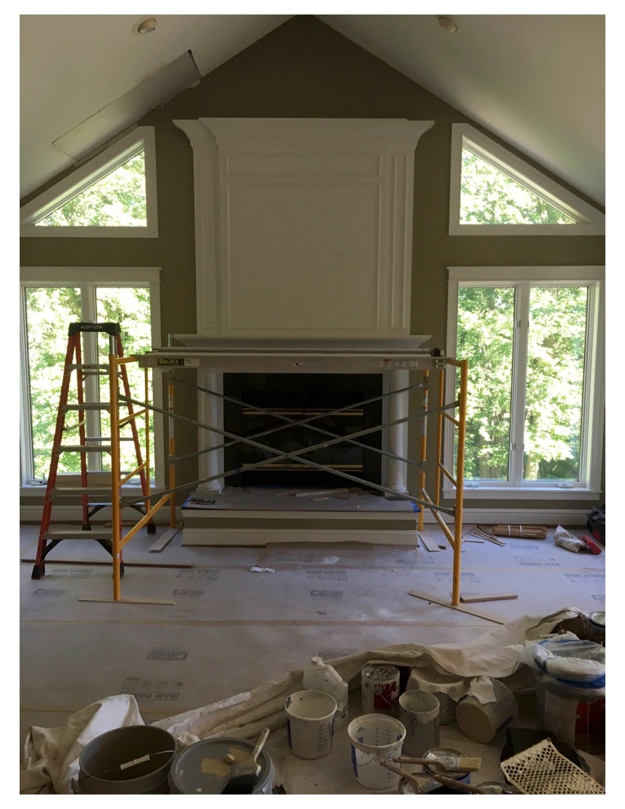 Fireplace under renovation with construction tools.