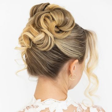 Elegant blonde updo hairstyle with soft curls and volume.