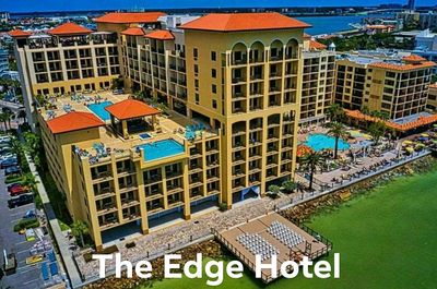 The Edge Hotel with pools and waterfront view under clear skies.