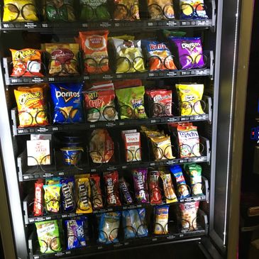 A snack vending machine filled with chips, candy, and other treats.