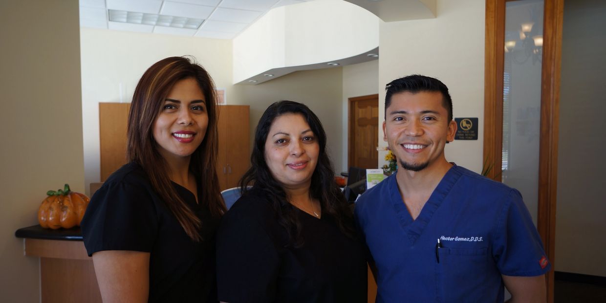 Dr. Gomez and his staff pose for a picture in the waiting room of Gomez Dental