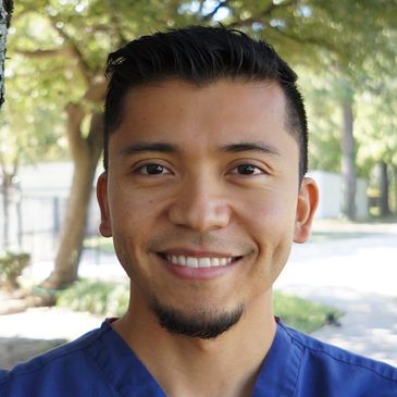 Hector M. Gomez, D.D.S., smiling for a photo outside his office