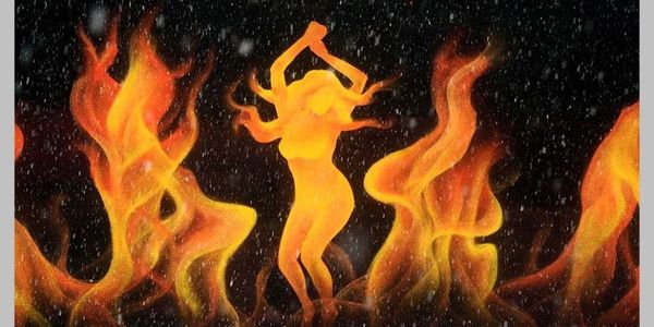 A fiery silhouette of a dancing woman surrounded by flames.