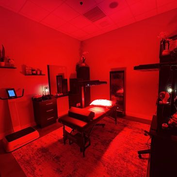 Massage or therapy room bathed in red light.