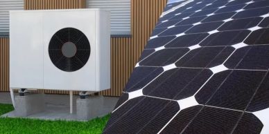 Solar panels and heat pump unit outside a building.