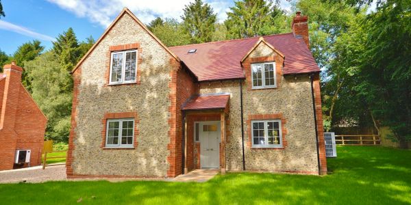 Charming countryside house with brick and stone exterior.