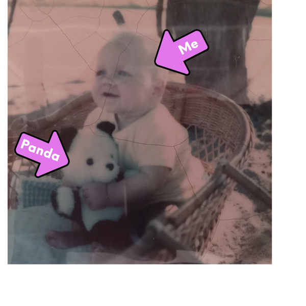 Baby holding stuffed panda. 